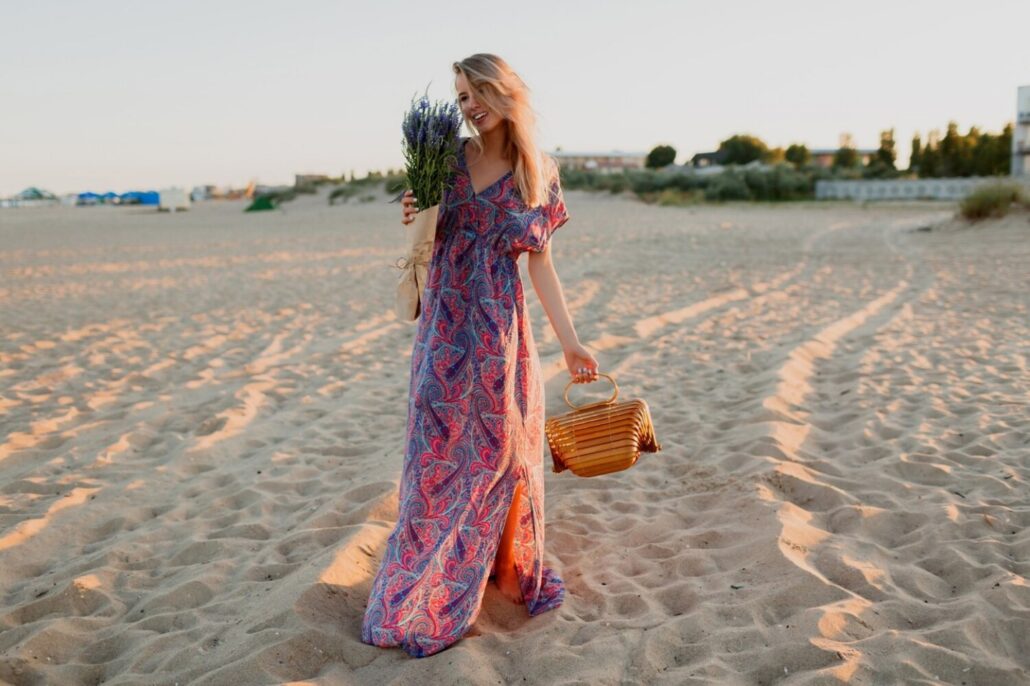 Think About Colour and Print
Colour can change the mood of a maxi dress. Soft shades can create a fresh daytime look, while deeper tones often feel more suited to evening events. Prints can also add interest without needing many accessories.
For weddings and special events, we should consider the invitation and setting before choosing a colour. A garden venue may suit floral prints, while a formal indoor event may call for a sleek solid colour.
We can also think about colours already in our wardrobe. A dress that works with shoes, bags, and jewellery we own will give us more styling options.
Know When to Choose an Evening Style
Formal occasions need a little more thought. When we compare evening dresses australia, we should look for details that match the level of formality. Satin finishes, flowing skirts, elegant necklines, and subtle embellishments can create a refined evening look.
The venue is important too. A formal dinner may suit a sleek maxi dress, while a cocktail event could call for a shorter hem or a more structured shape.
We can keep accessories simple when the dress has strong details. A small clutch, neat shoes, and simple jewellery may be enough. The aim is balance. Every part of the outfit should work together.
Style a Maxi Dress for Different Events
One well-chosen maxi dress can work for more than one occasion. Small changes can give the outfit a fresh look.
For daytime, we can pair a flowing dress with simple sandals and a light bag. For dinner, we can switch to heels or dressy flats and add delicate jewellery. For a formal event, a structured clutch and refined accessories can make the same dress feel more polished.
When we need a more playful look, cocktail dresses australia can also offer inspiration through colour, shape, and detail. We can use these ideas when choosing a maxi dress without making the outfit feel too formal.
A few useful styling options include:
•	Add a belt to define the waist.
•	Use a cropped jacket for cooler weather.
•	Choose simple jewellery for printed dresses.
•	Pick statement earrings when the neckline is plain.
•	Match shoes to the venue and walking needs.
Check the Fit Before Buying
Fit is one of the most important parts of choosing any dress. We should check the shoulders, bust, waist, and length carefully. The dress should sit comfortably without pulling or feeling too loose.
Length deserves special attention with maxi dresses. A hem that is too long can make walking difficult, especially on stairs or outdoor surfaces. A hem that is too short may change the intended look.
We can also check whether the dress allows easy movement. Sitting down, walking, and raising our arms should not feel difficult. Online shopping requires extra care, so we should always check the size guide and garment measurements before ordering.
Consider Versatility and Long-Term Value
